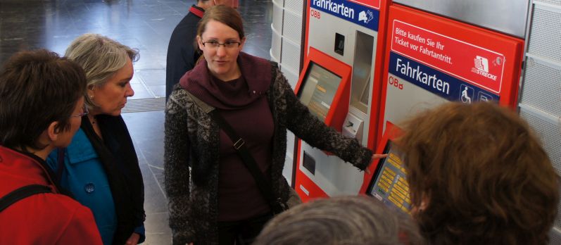 A volunteer demonstrating how to buy train tickets to hiking club members, 2011-Apr (P.Potter)